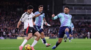 Raul Jimenez (left) scores for Fulham under pressure from Arsenal's William Saliba