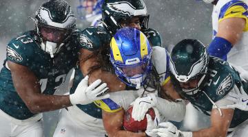 Jordan Whittington of the Los Angeles Rams is tackled by the Philadelphia Eagles during the NFC Divisional Playoff game