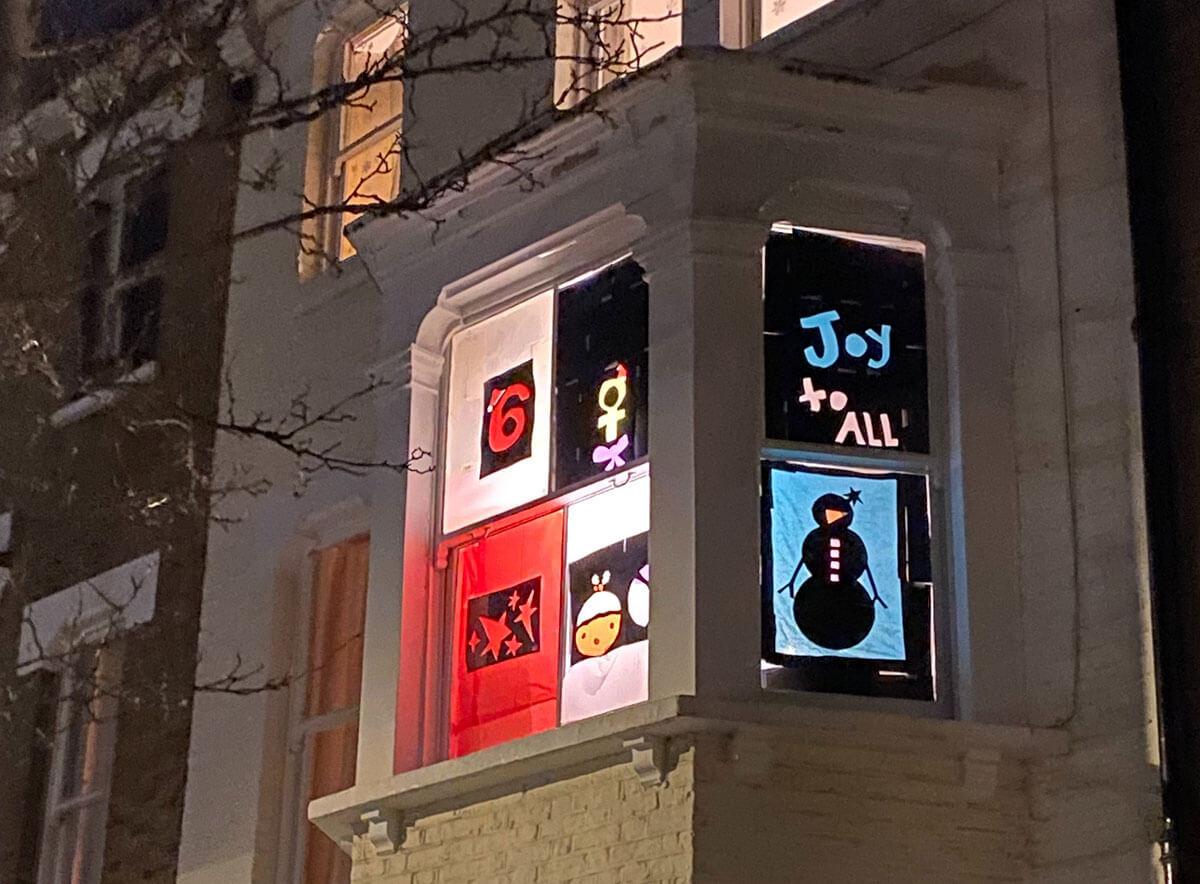 A Brook Green window illuminated as part of the Living Advent Calendar