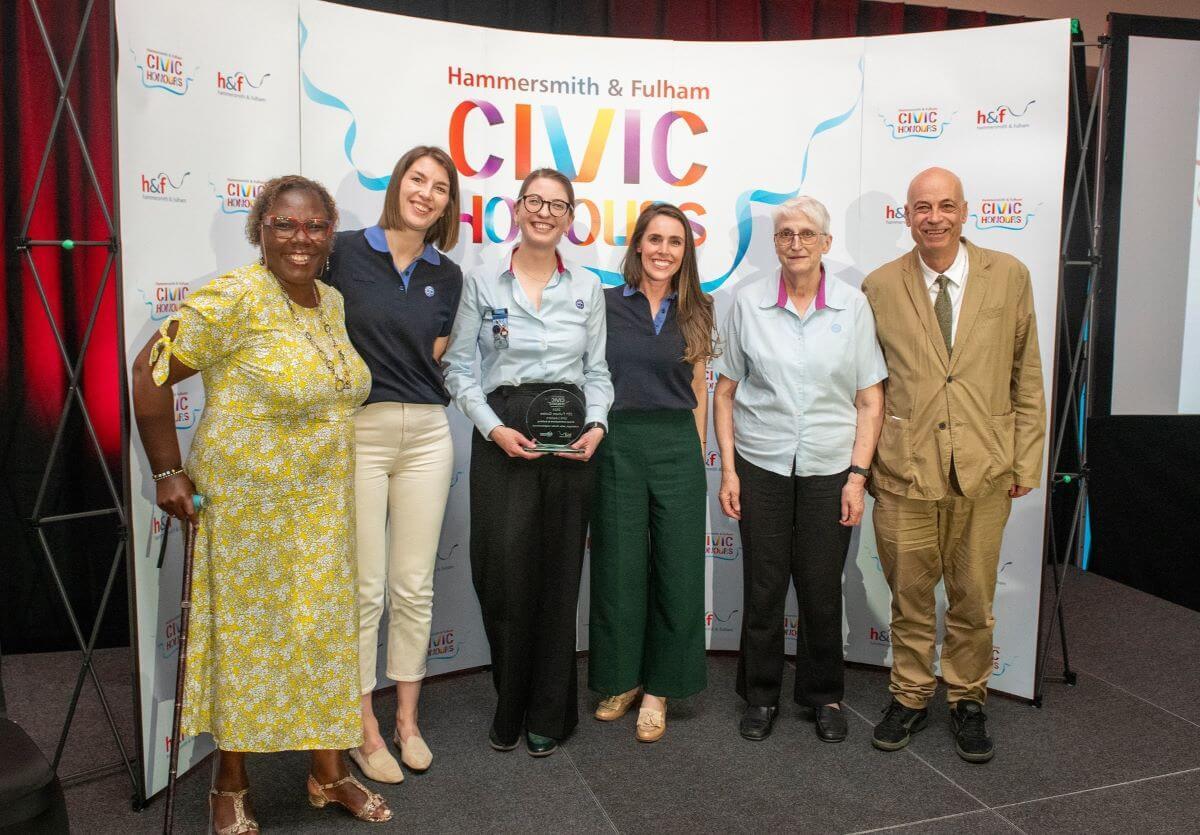 Cllr Sharon Holder (left) and Cllr Adam Peter Lang (right) present the 25th Fulham Guides Unit with their Civic Honour