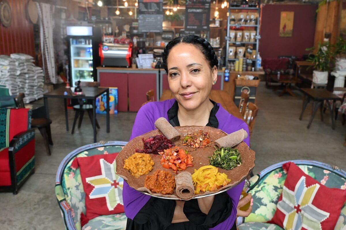 Nazareth Kelif at her restaurant, Delina with a platter called beyaynetu