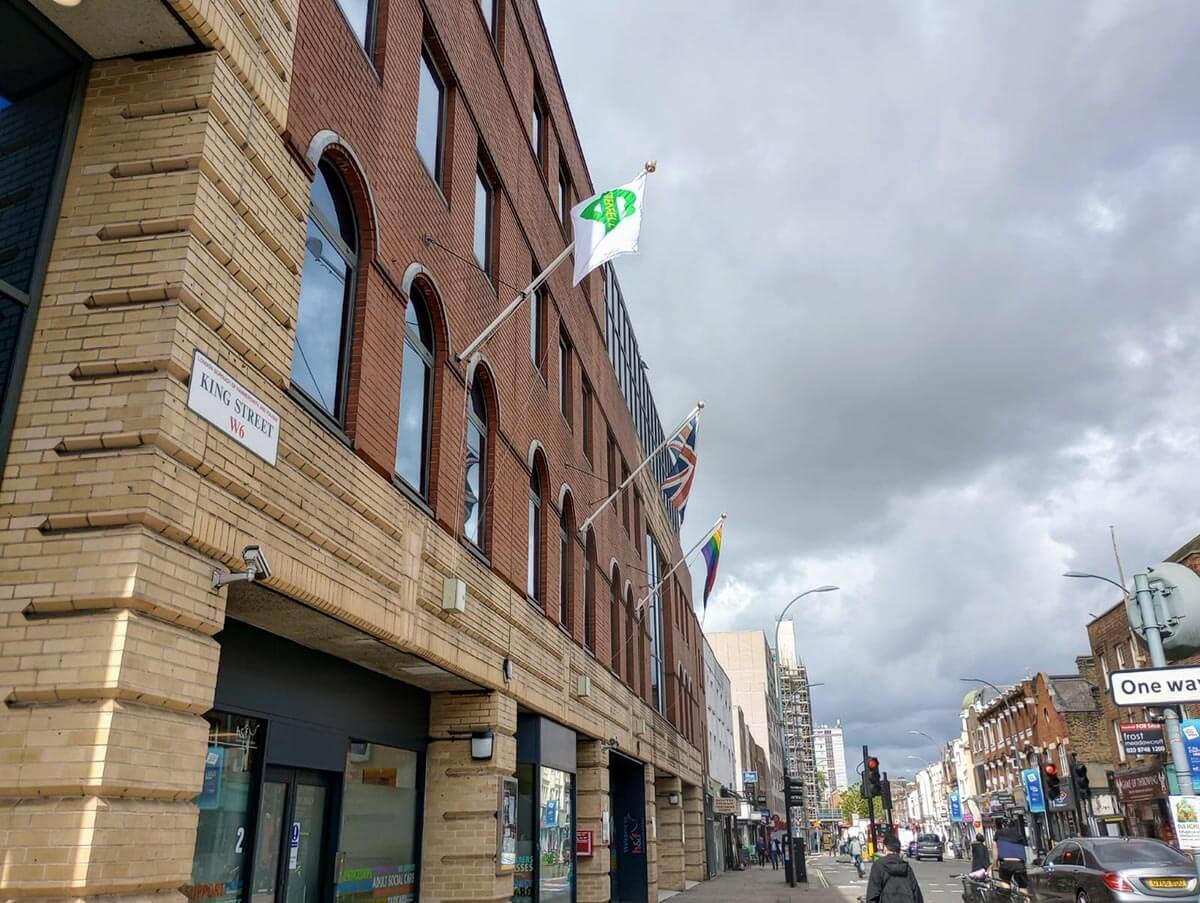 Grenfell flag flying outside 145 King Street in Hammersmith