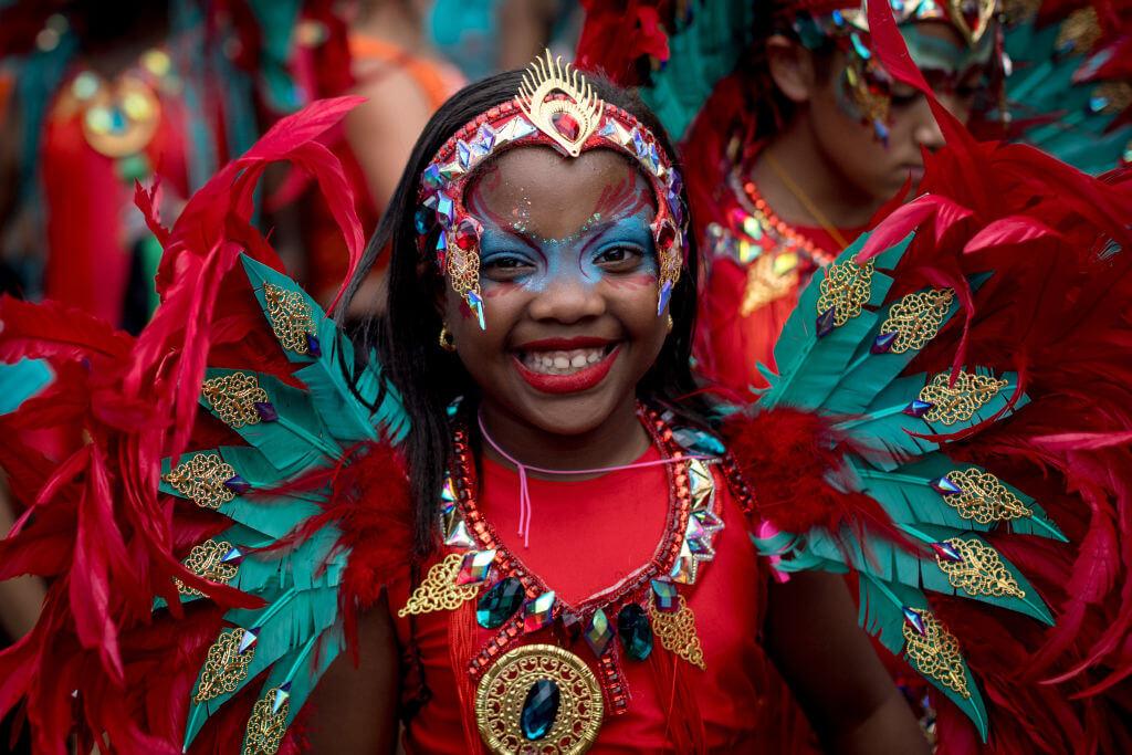 A young performer parades in costume on families and children's day at Notting Hill Carnival 2023