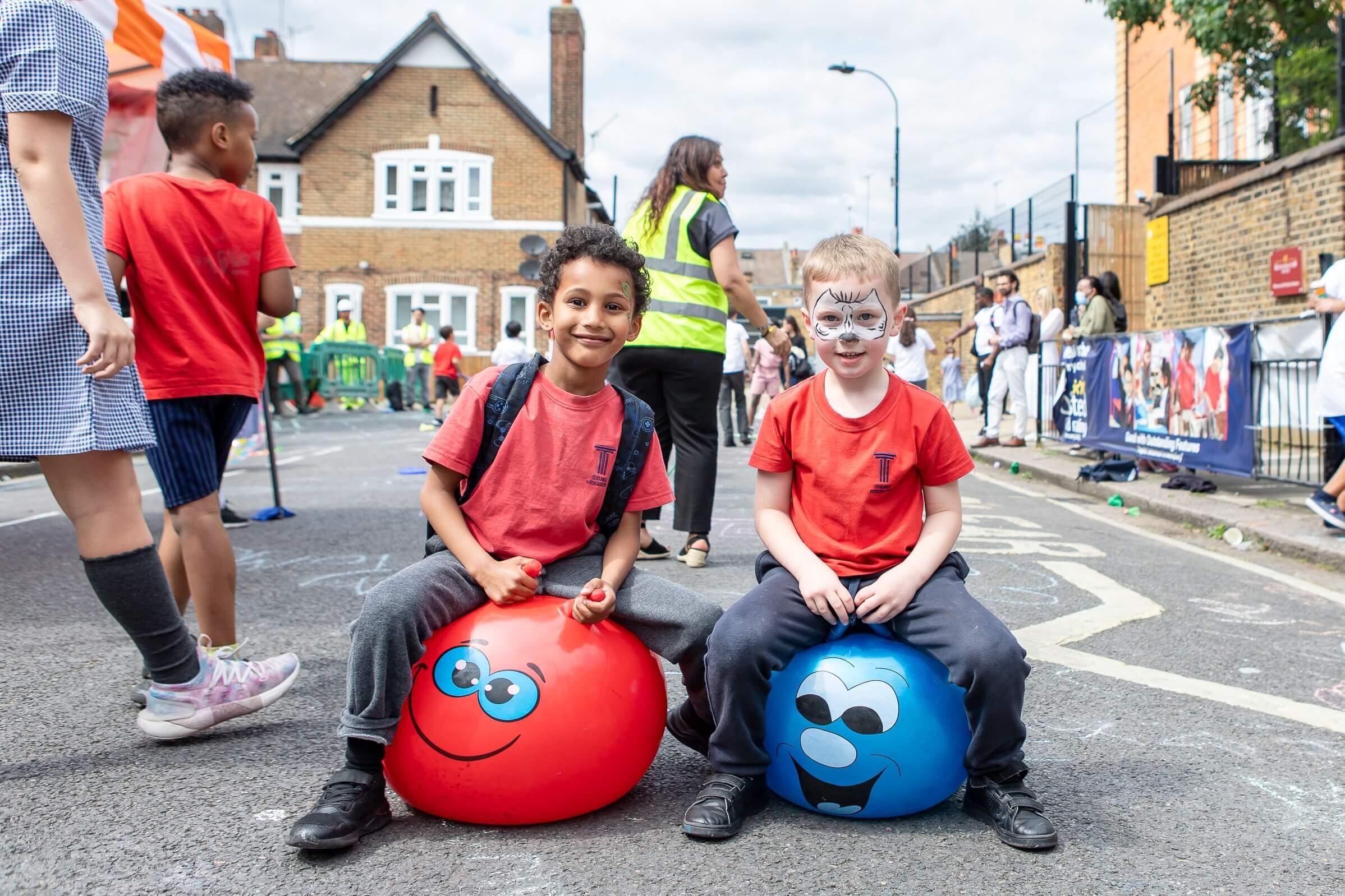 Children on space hoppers at Play Street in Colwith Road.