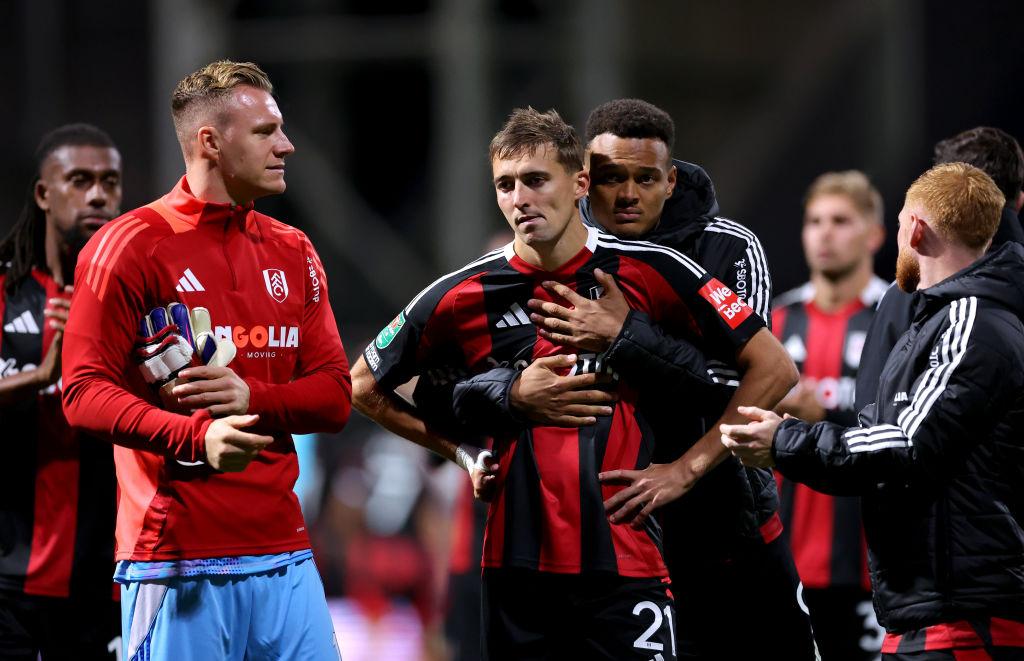 Timothy Castagne is comforted by teammate Rodrigo Muniz after missing during the penalty shoot-out 