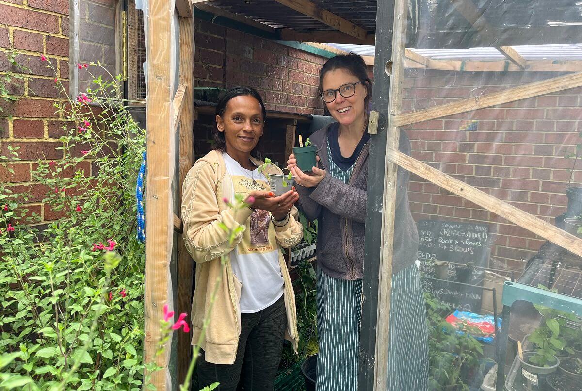 Gardener Lishan Beine (left) and artist Emily Fuller (right) in the White City Meanwhile Garden.