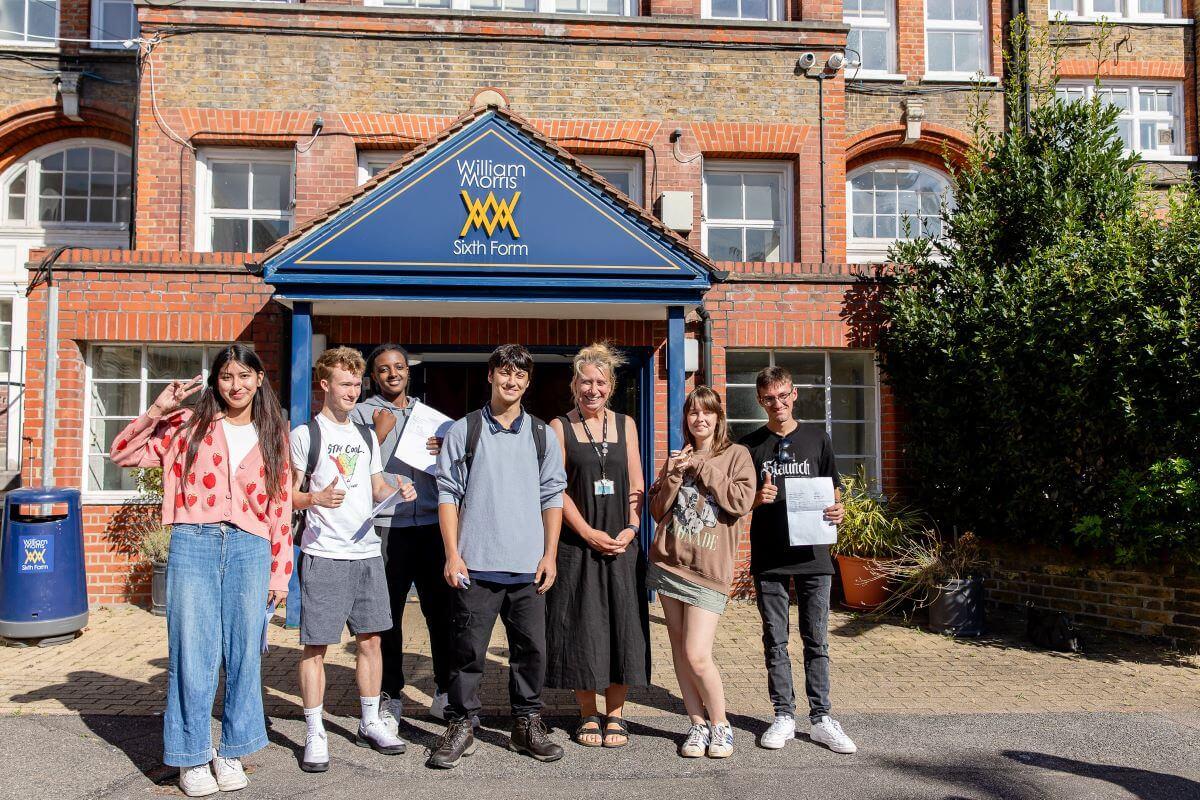 Students collect their A-level results with Mary Berrisford, school principal (centre right)