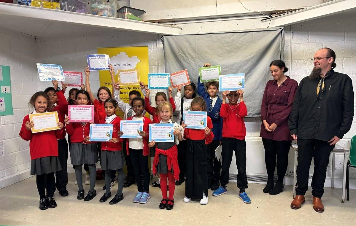 Writing club members pose with their certificates and staff from Write-London (right)