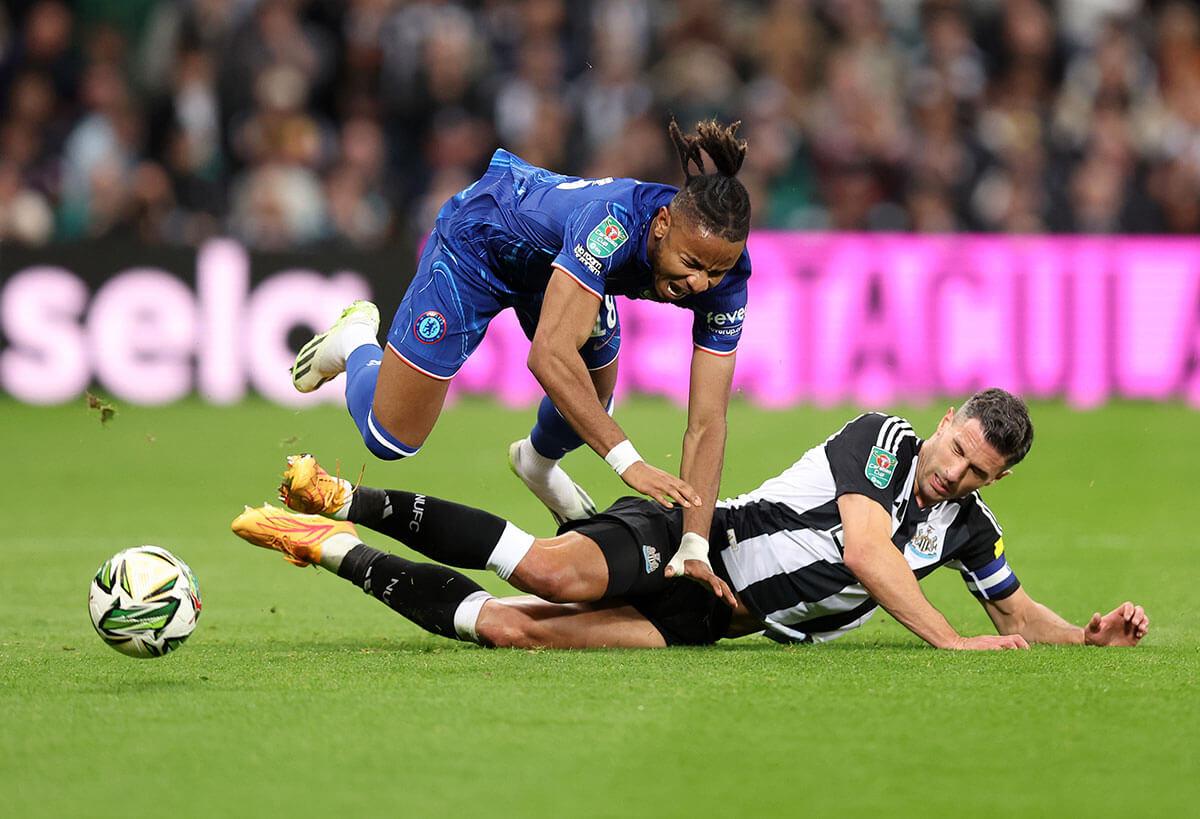 Chelsea's Christopher Nkunku is fouled during the Carabao Cup game at St James' Park