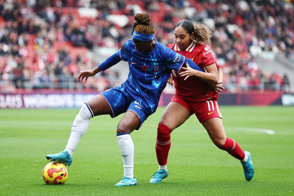 Kadeisha Buchanan battles for possession with Olivia Smith