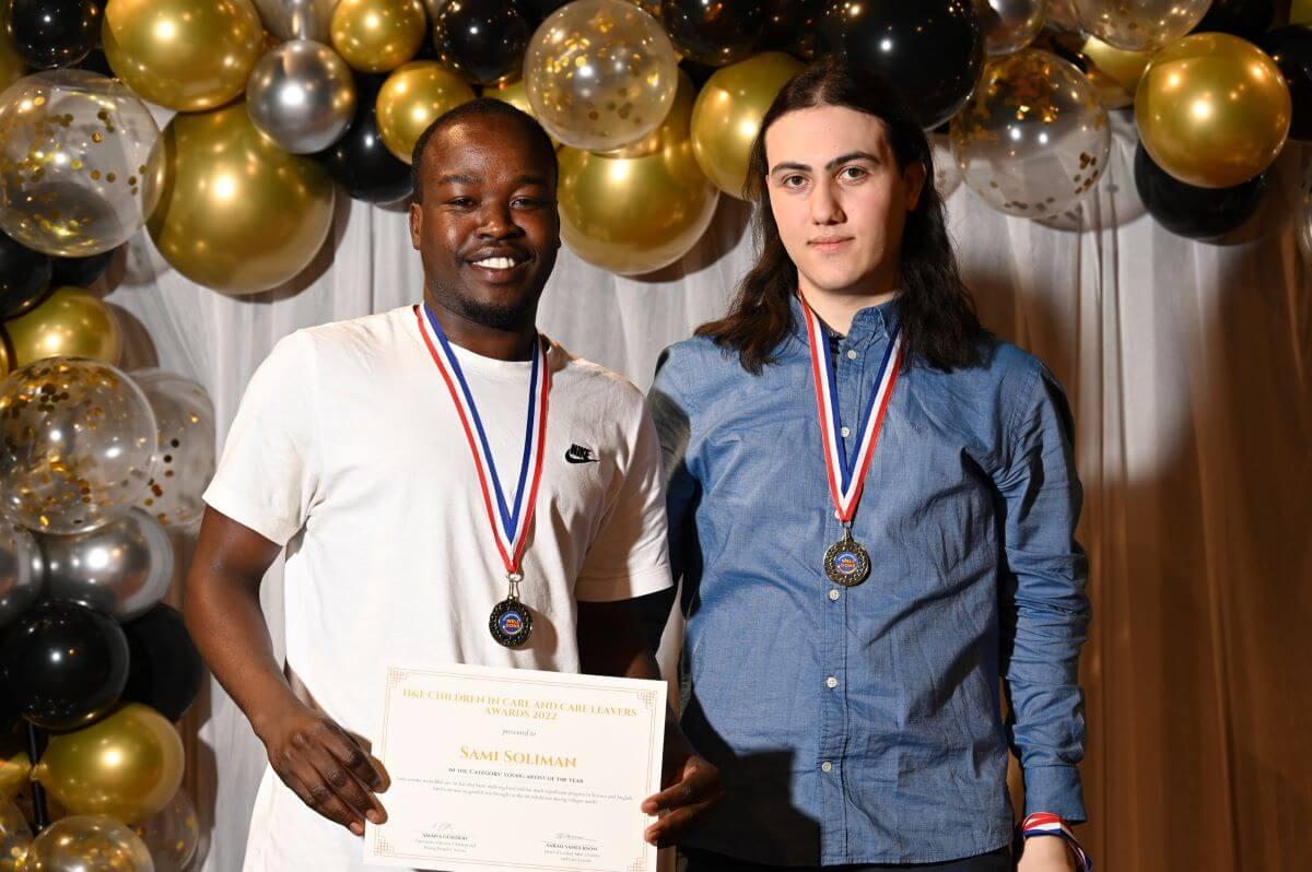 Sami Soloman (left), with friend Erik Karyan (right), receives award for his academic achievements