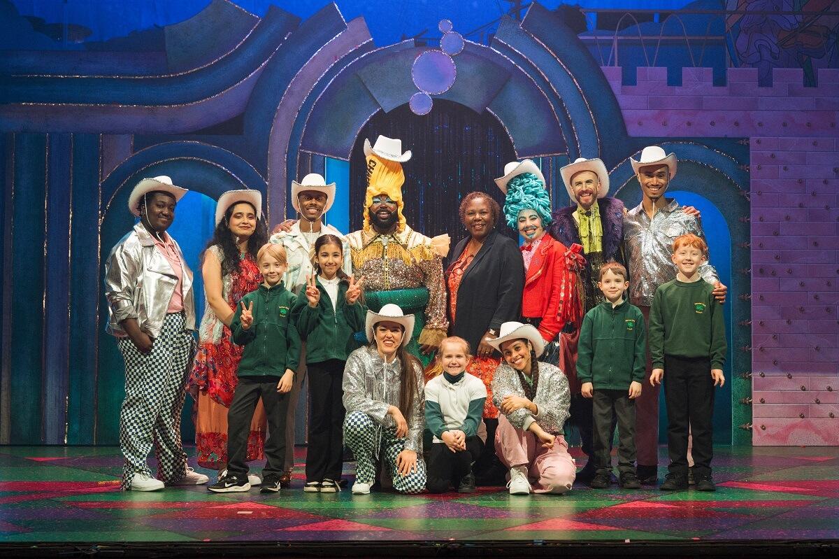 Lyric panto cast 2024 with H&F Cllr Sharon Holder (back, centre) and pupils from Wendell Park primary school in Shepherds Bush