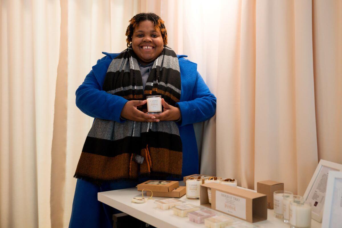 Nicole, founder of Shades of Blackness, poses with her products