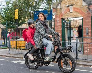 Adult and child on an e-bike.