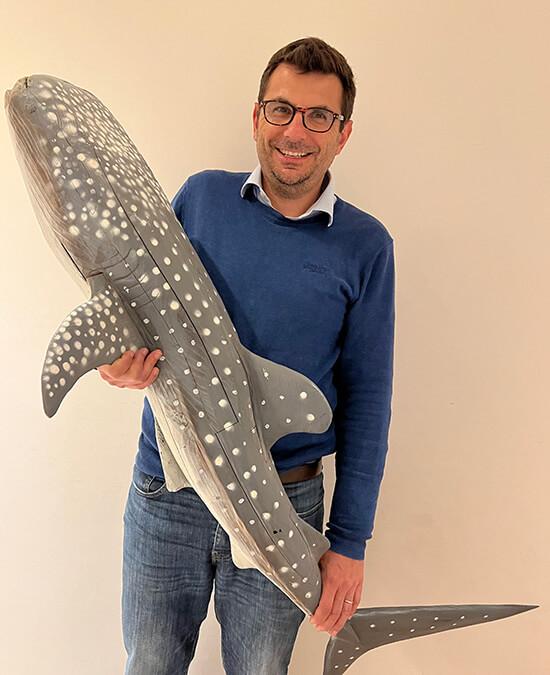Artist Julien Hipeau with a shark sculpture