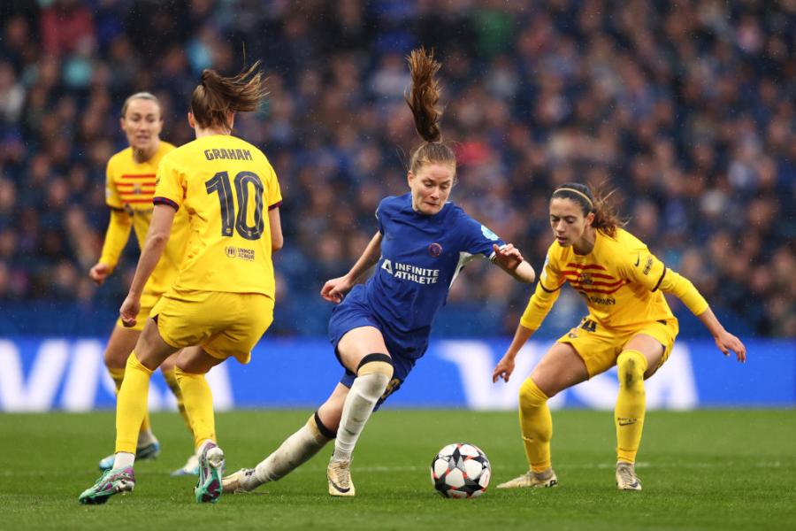 Sjoeke Nuesken runs with the ball under pressure from Aitana Bonmati and Caroline Graham Hansen 