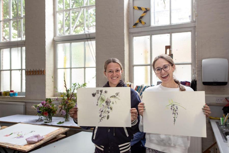 Students show off their watercolour painting at the open day