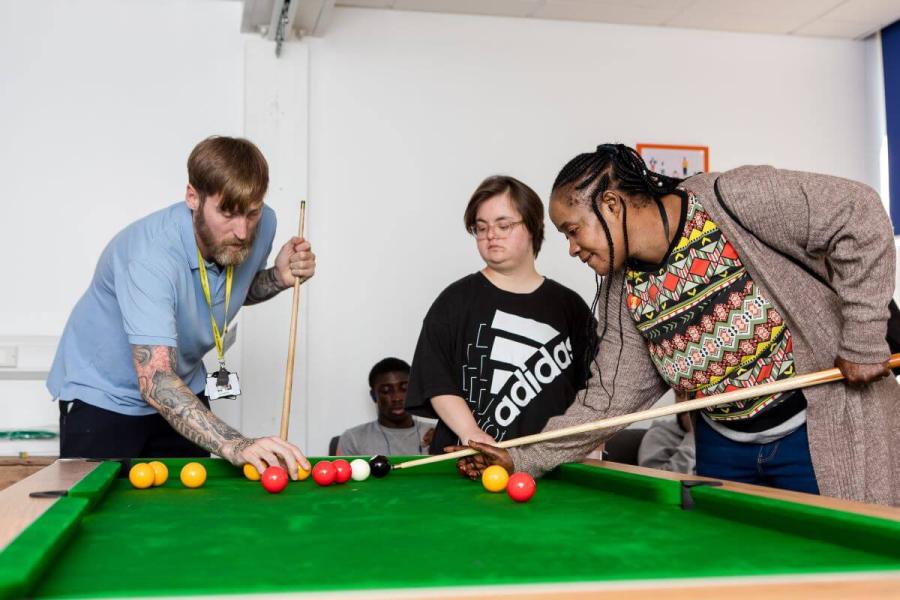 Residents and staff play pool at Our Place