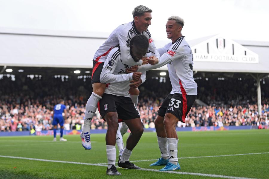 Alex Iwobi celebrates with Harry Wilson and Antonee Robinson