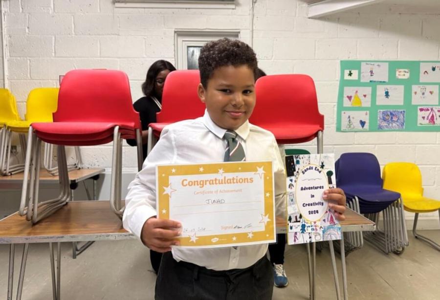 Junaid with the anthology and his certificate