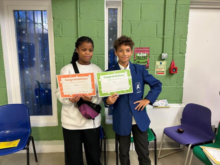 Malia (left) and Max (right) with their writing club certificates