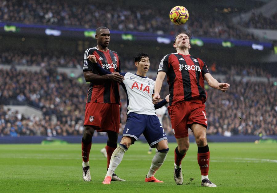 Tottenham's Son Heung-Min tussles with Sander Berge and Issa Diop