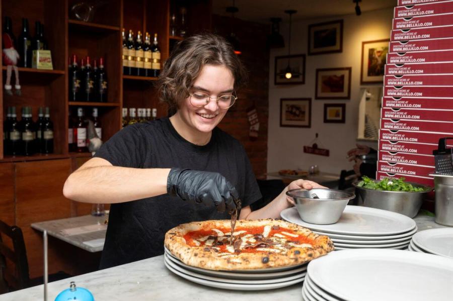 Chef adds toppings to pizza at Bellillo, 255 Munster Road