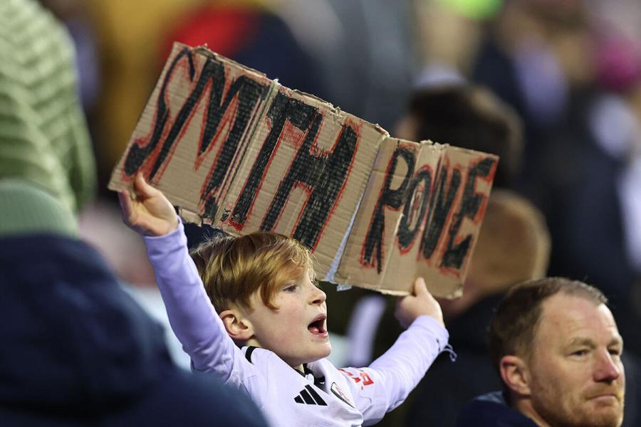 A young Fulham fan holds up a home made banner for Emile Smith Rowe 