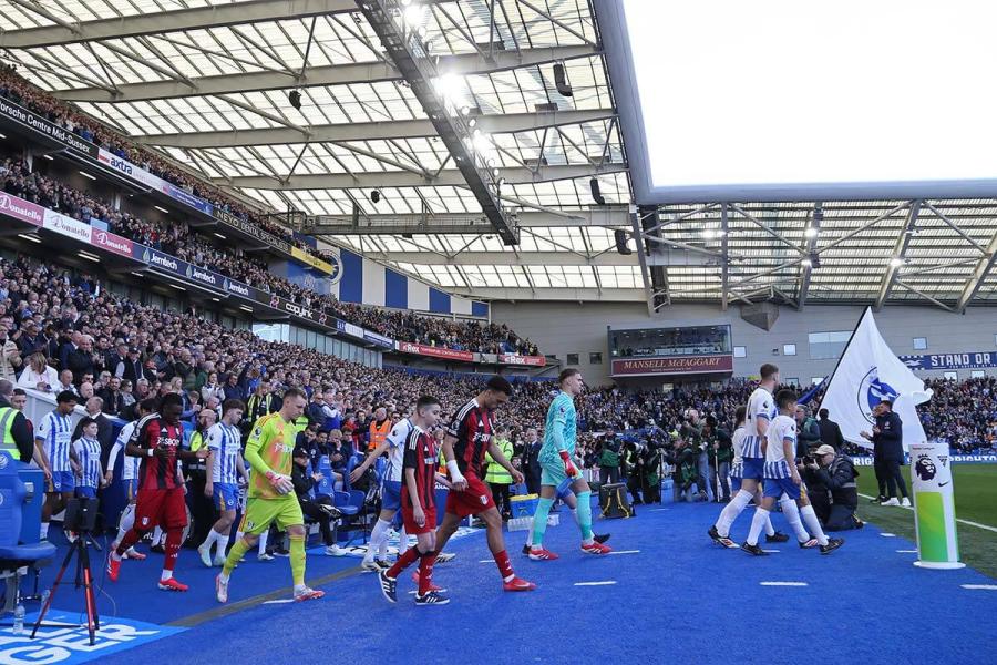 The players walk out at Amex Stadium